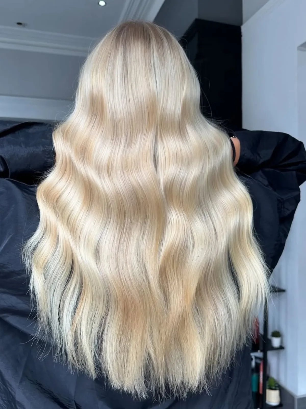 Model with long, glossy, bright champagne blonde hair. 