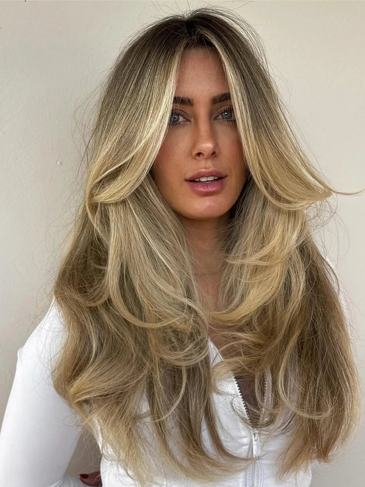 Model with long Old Money Blonde hair featuring lived-in roots.