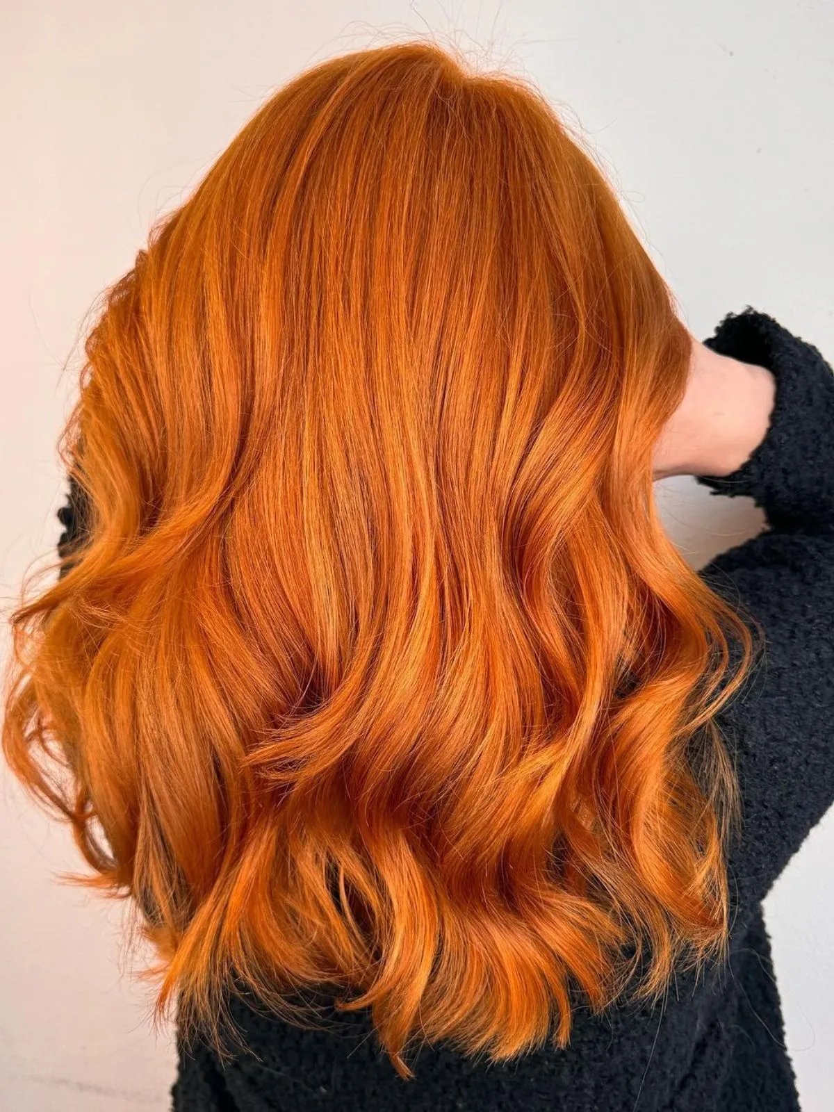 Model with long, tousled, vibrant ginger hair.