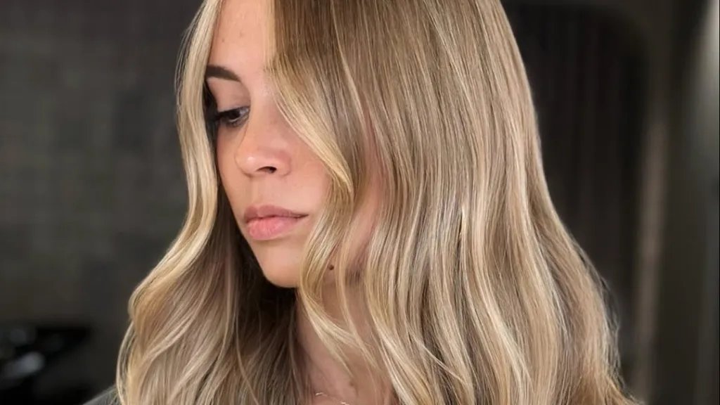 Model with long, blonde hair featuring multi-tonal highlights.