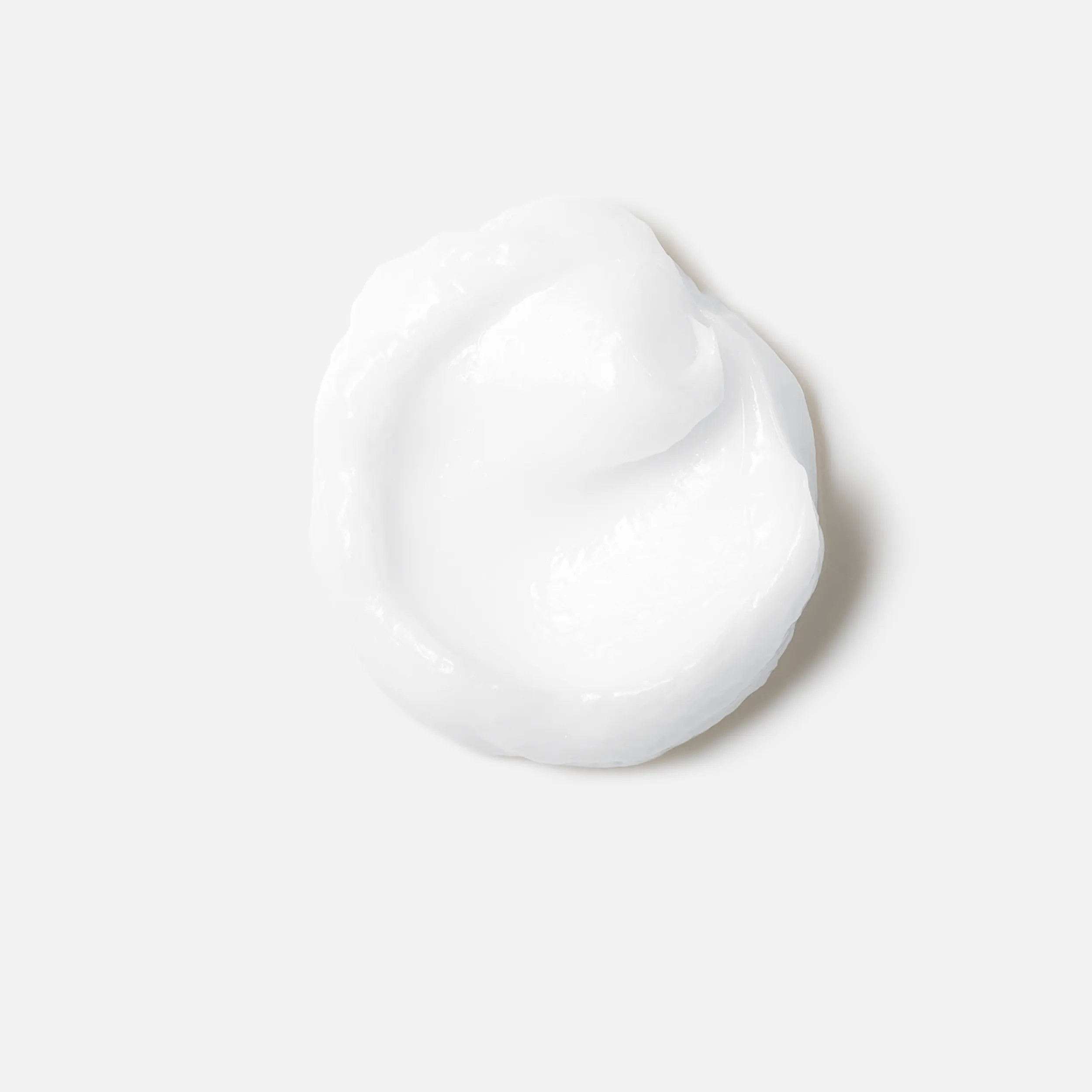 Close-up photograph of a circular blob of Fusion Intense Repair Conditioner product on a white background.