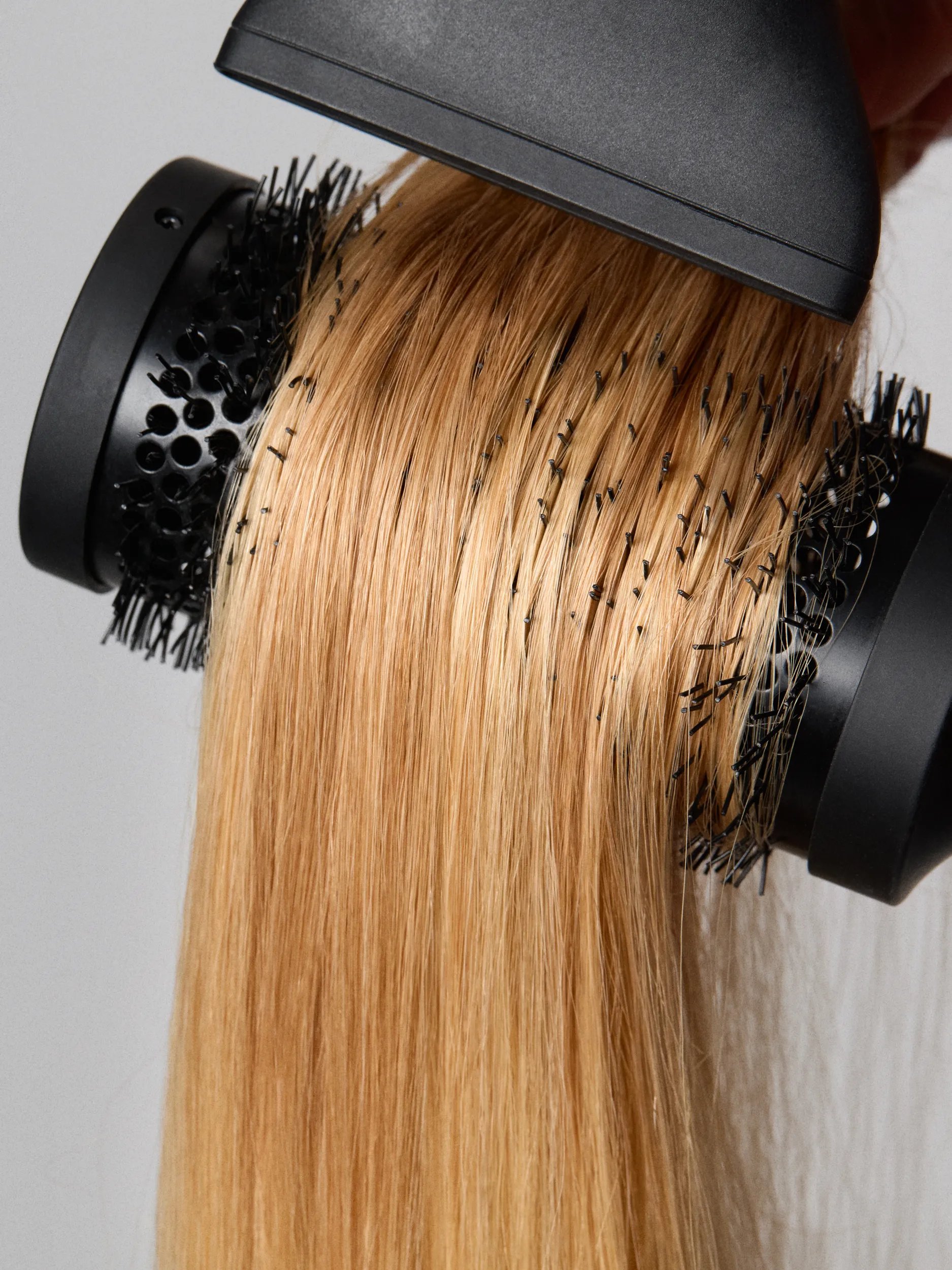 Blonde hair being combed