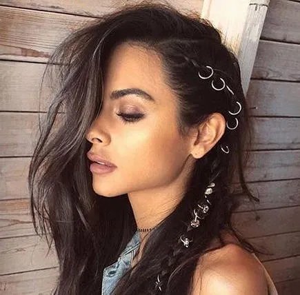 Woman with black wavy hair styled with hair rings