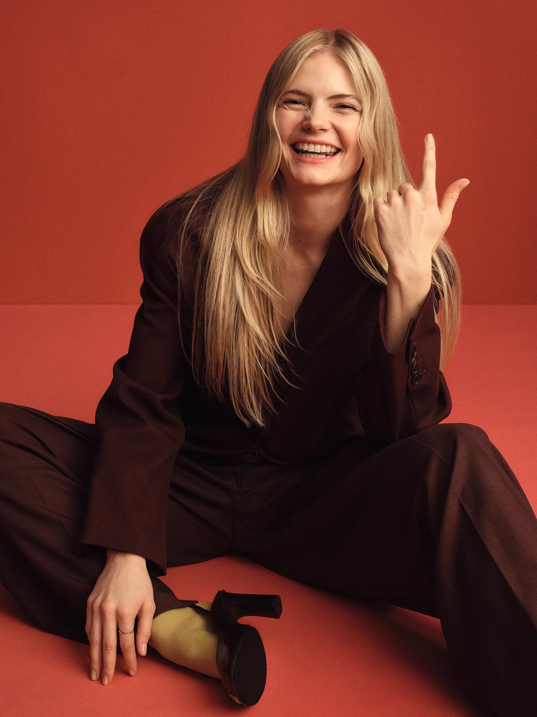 Photograph of a young woman with long, blond hair smiling to the camera