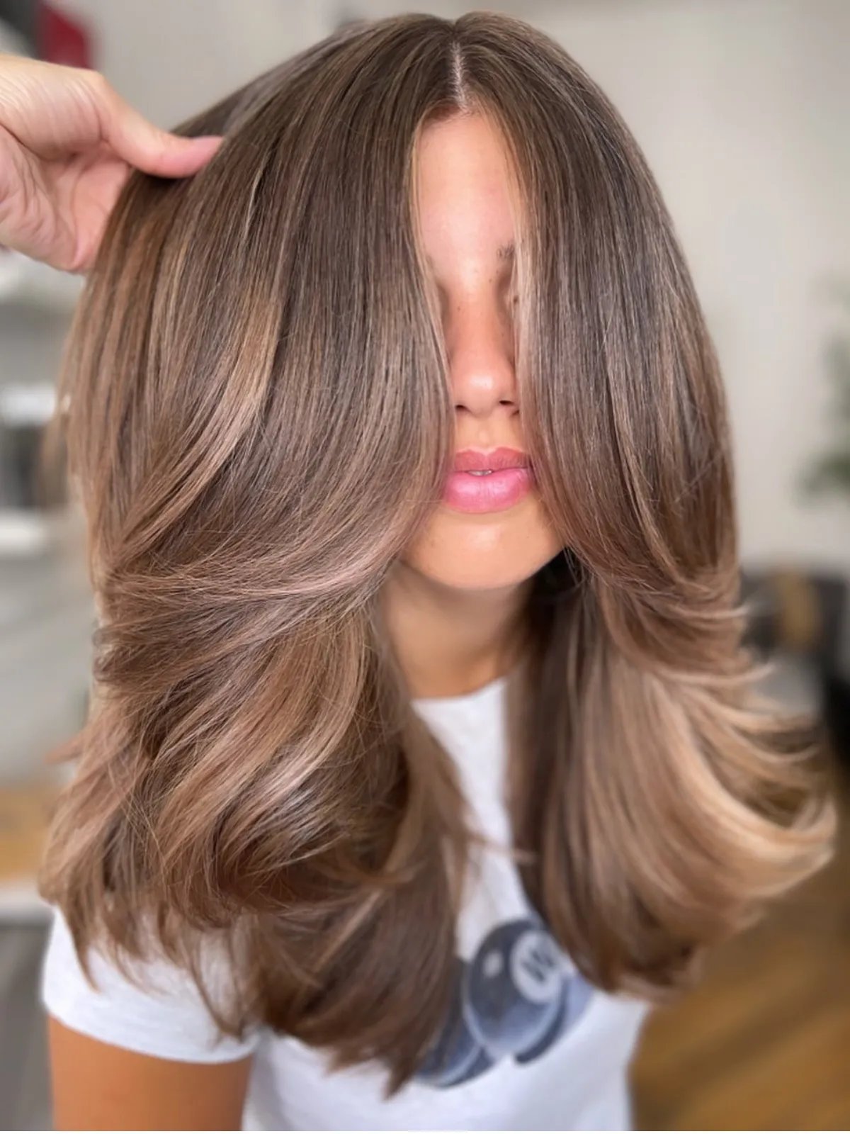 Model with shiny, light brown hair, featuring silky beige tones through the mid-lengths.