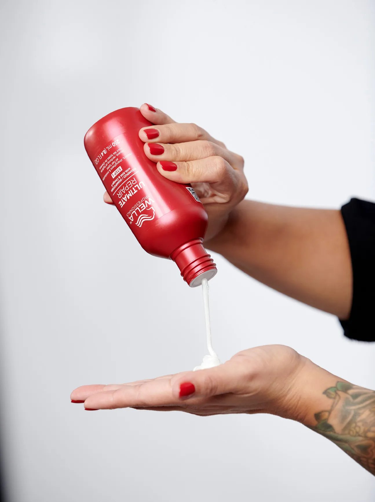 Model with Ultimate Repair Shampoo bottle