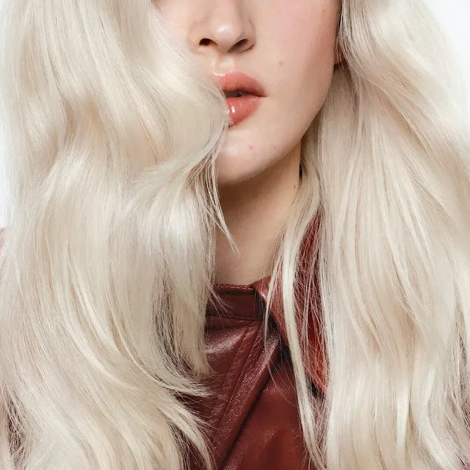Close-up of model’s icy blonde, wavy hair.