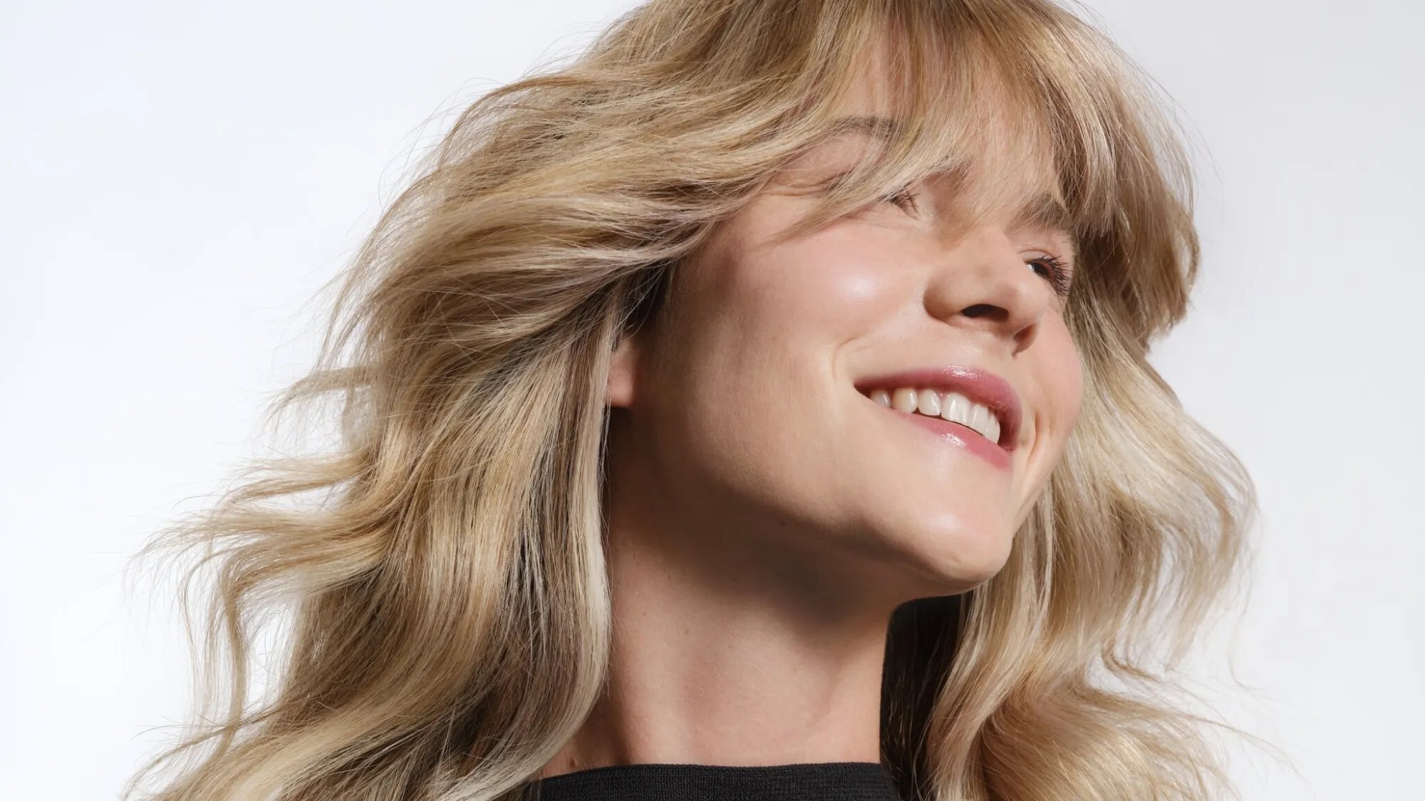 Model with long, blonde, tousled waves.