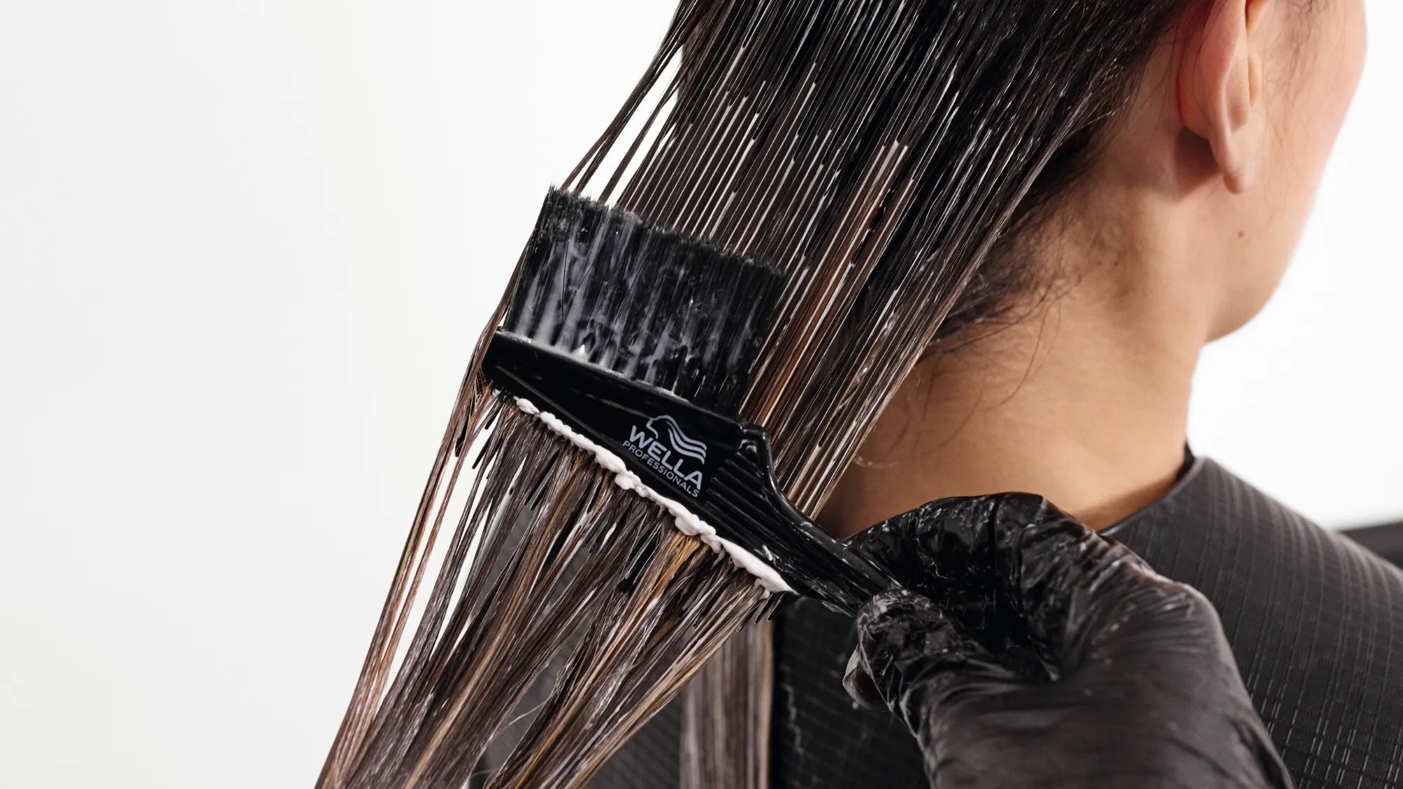 Smoothfiller solution is brushed through model’s hair.