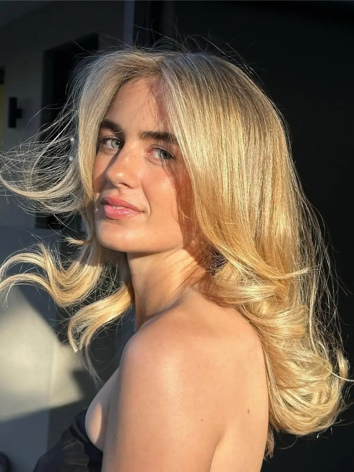 Model with bouncy blow-dried, golden blonde hair.