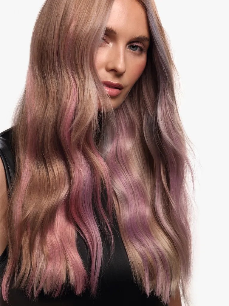 Model with ash blonde hair featuring pink and purple pastel highlights.