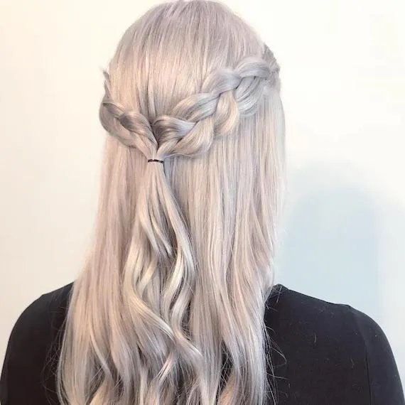 Back of woman’s head with ice blonde, half-up inside out braid, created using Wella Professionals.