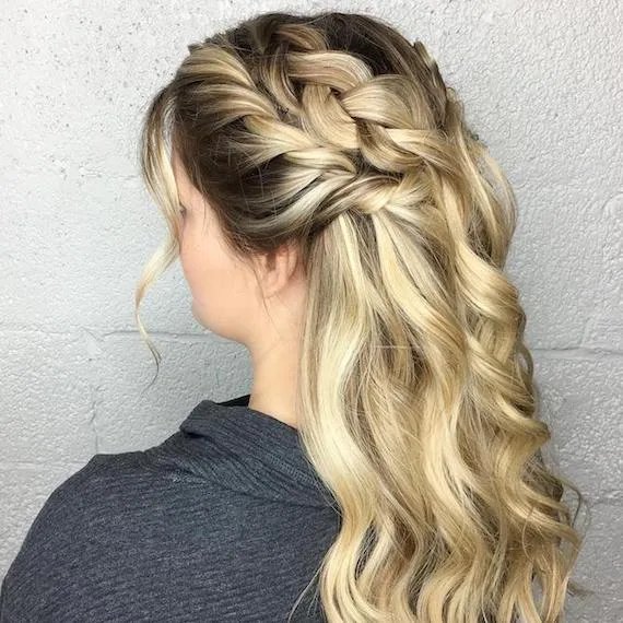 Photo of woman with hair styled in a half-updo for her wedding hairstyle, created using Wella Professionals