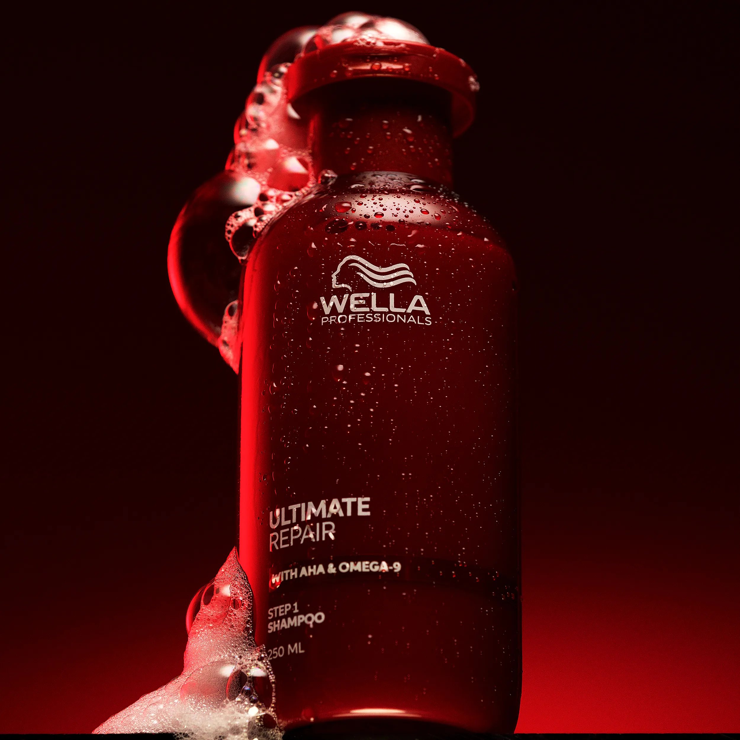 Packshot of Ultimate Repair Shampoo over a red background
