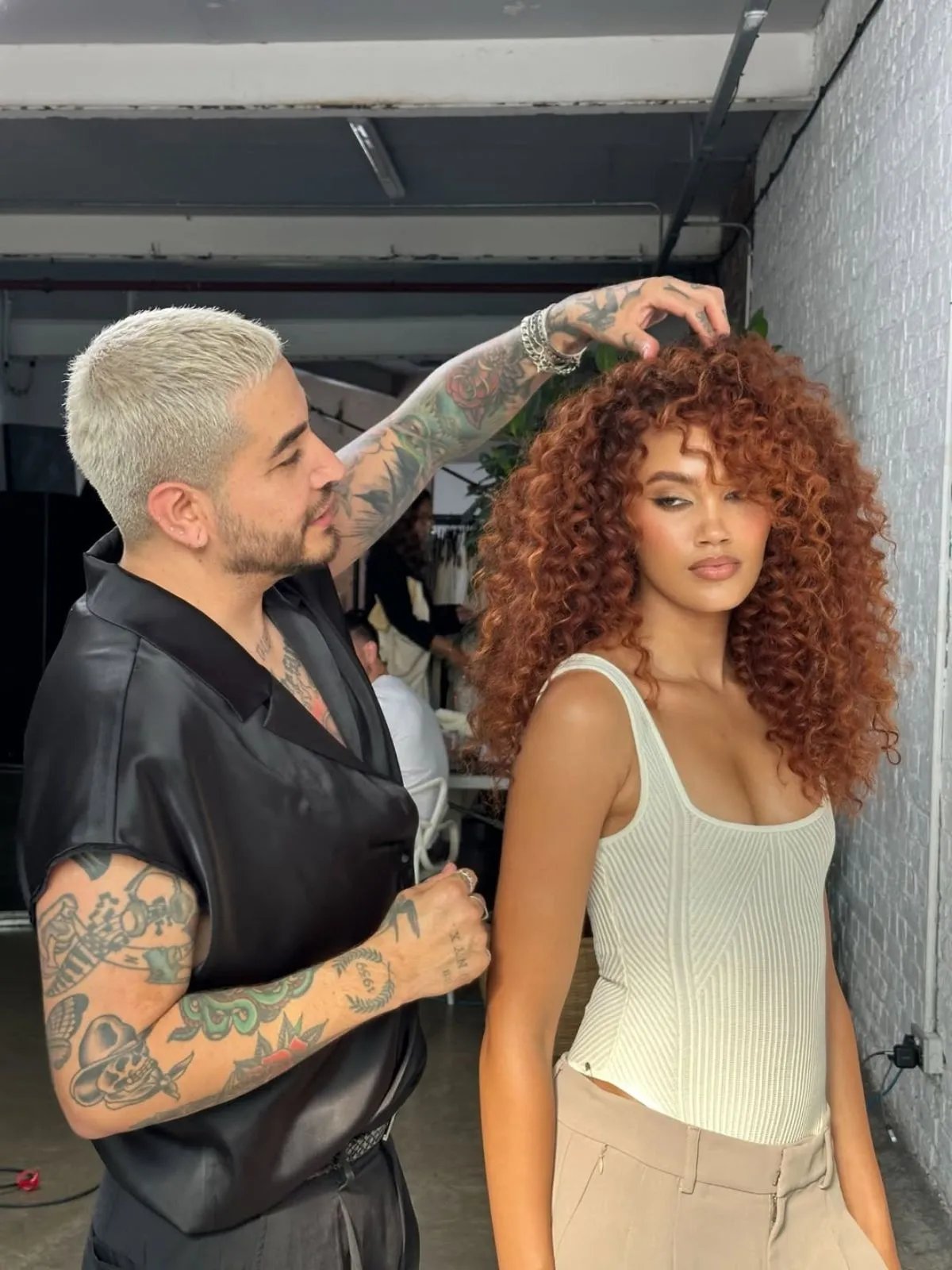 Model’s copper brown curls are styled by Daniel Mora.