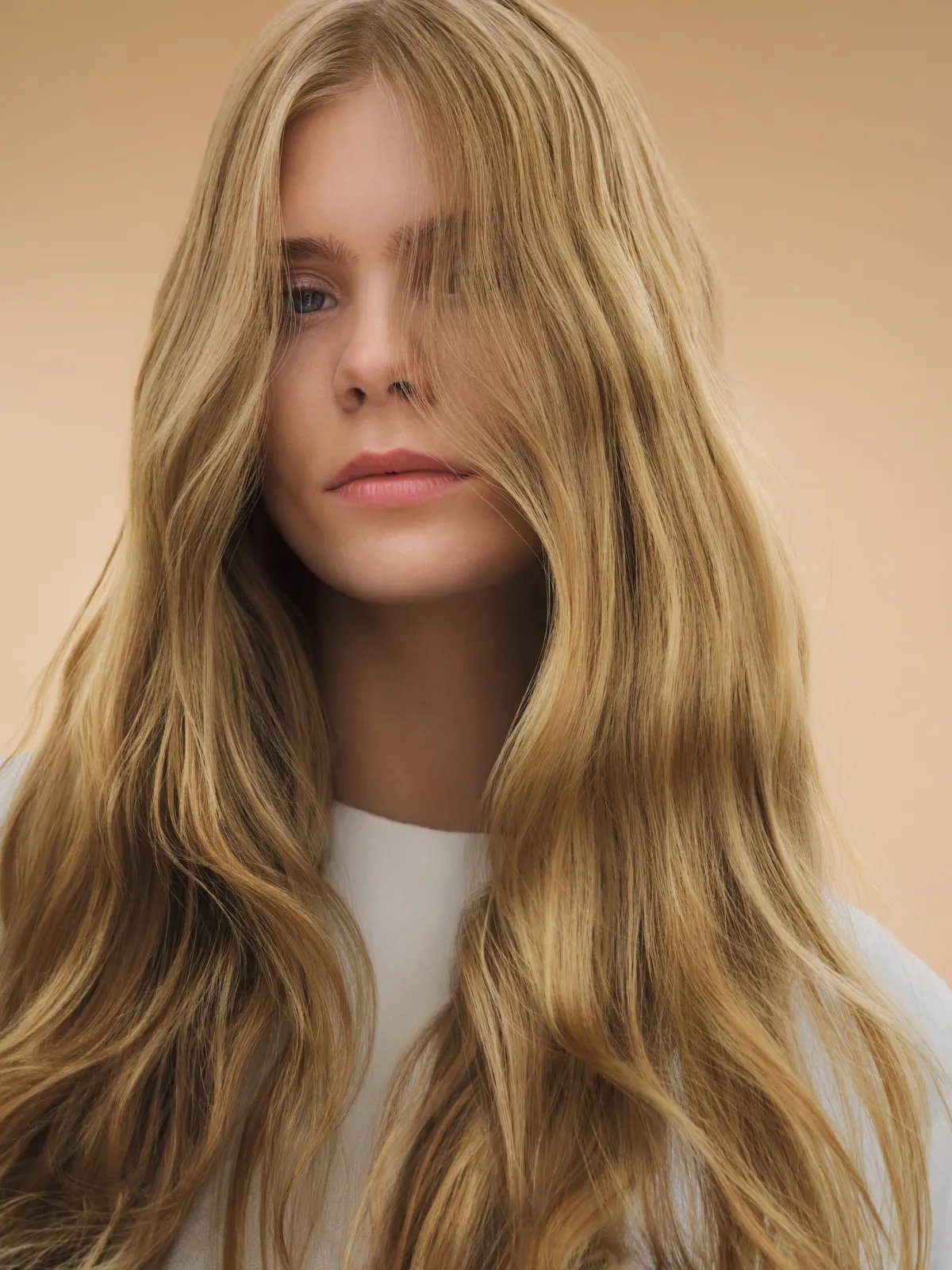 Model with long, tousled, honey blonde hair.