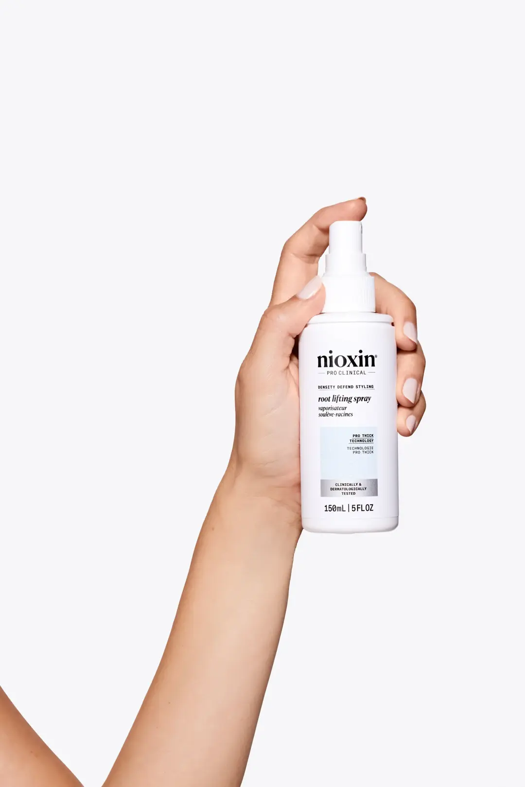 Nioxin Root Lifting Spray bottle in hand