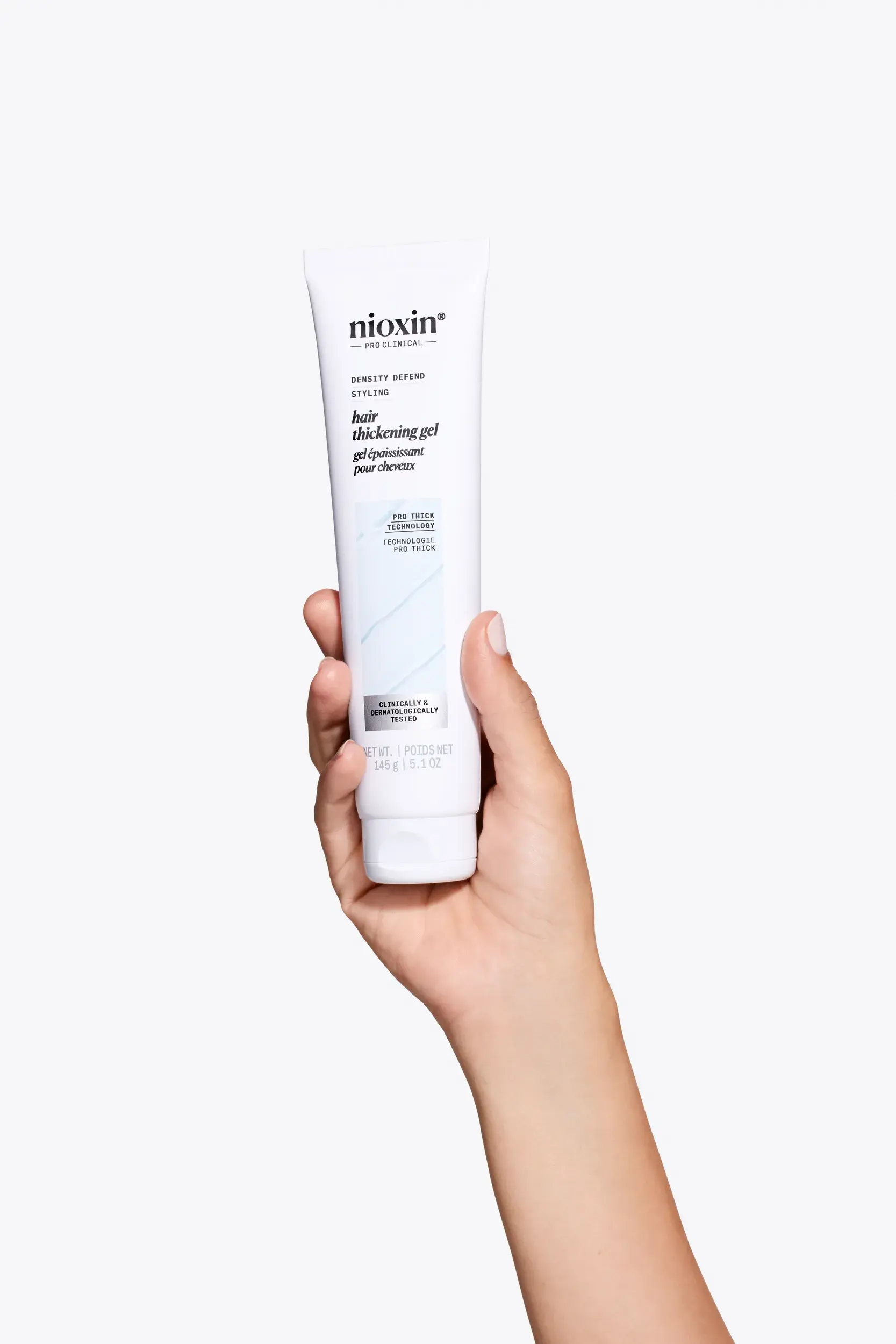 Nioxin hair thickening gel in hand against white background