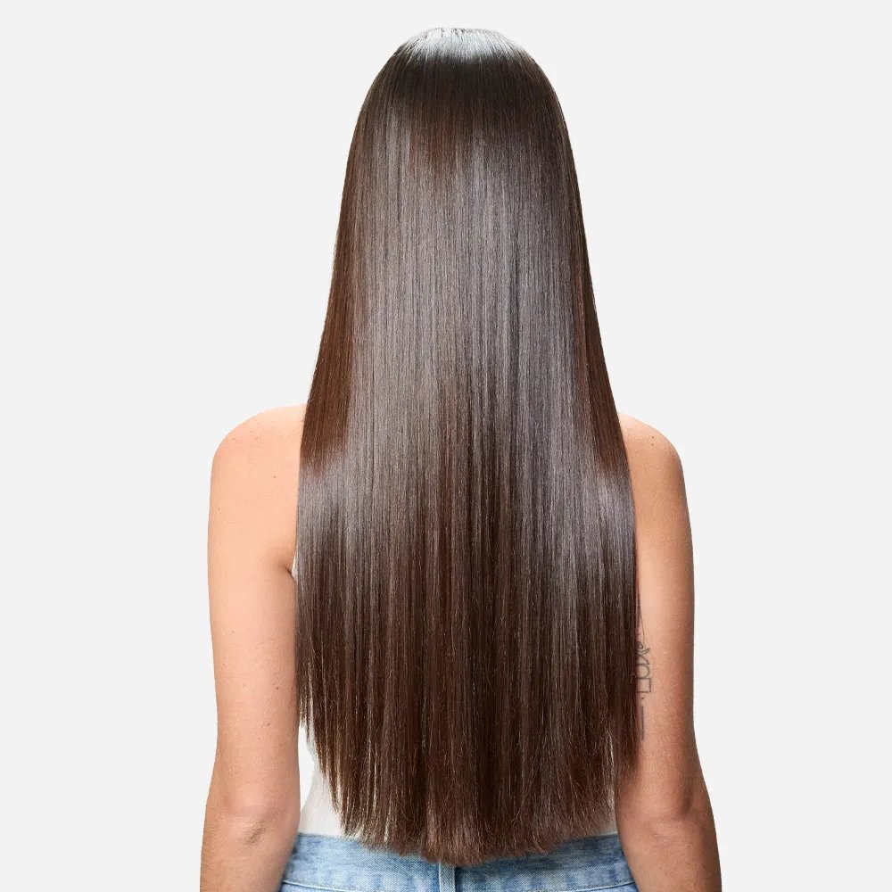 Before and after showing model’s long, brown, frizzy hair looking smooth and glossy after a SmoothFiller service.