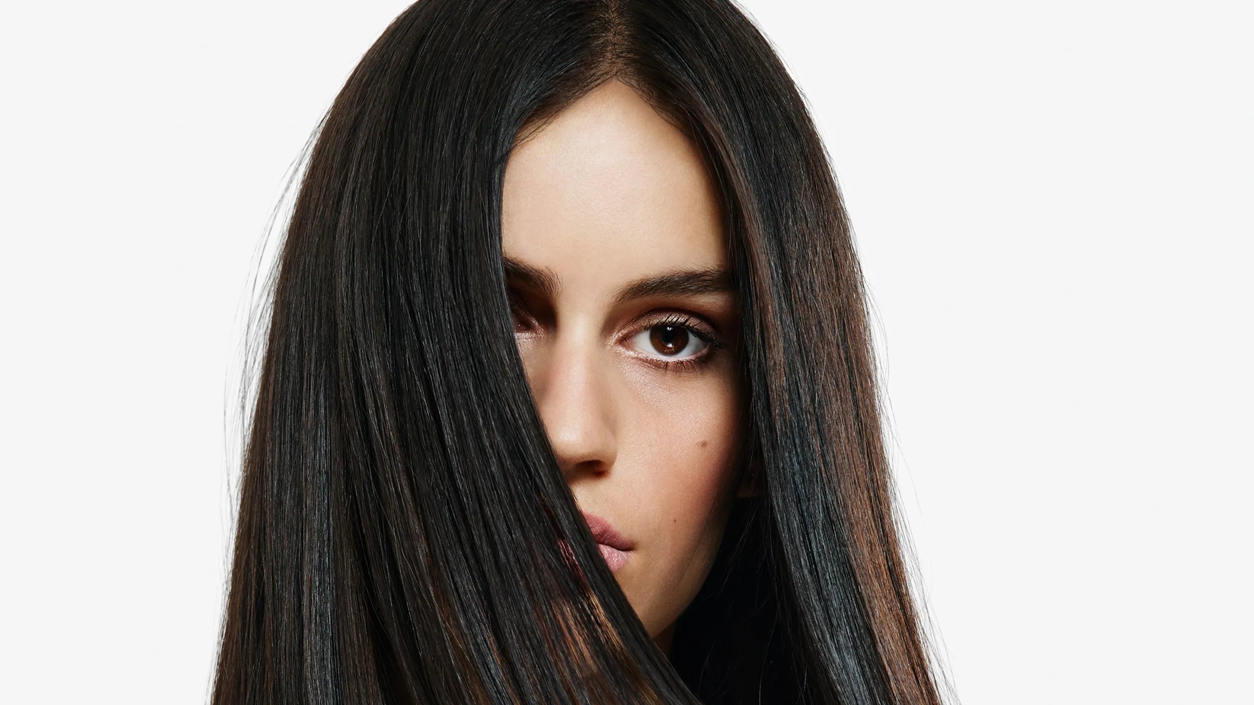 A woman facing the camera with long straight black hair