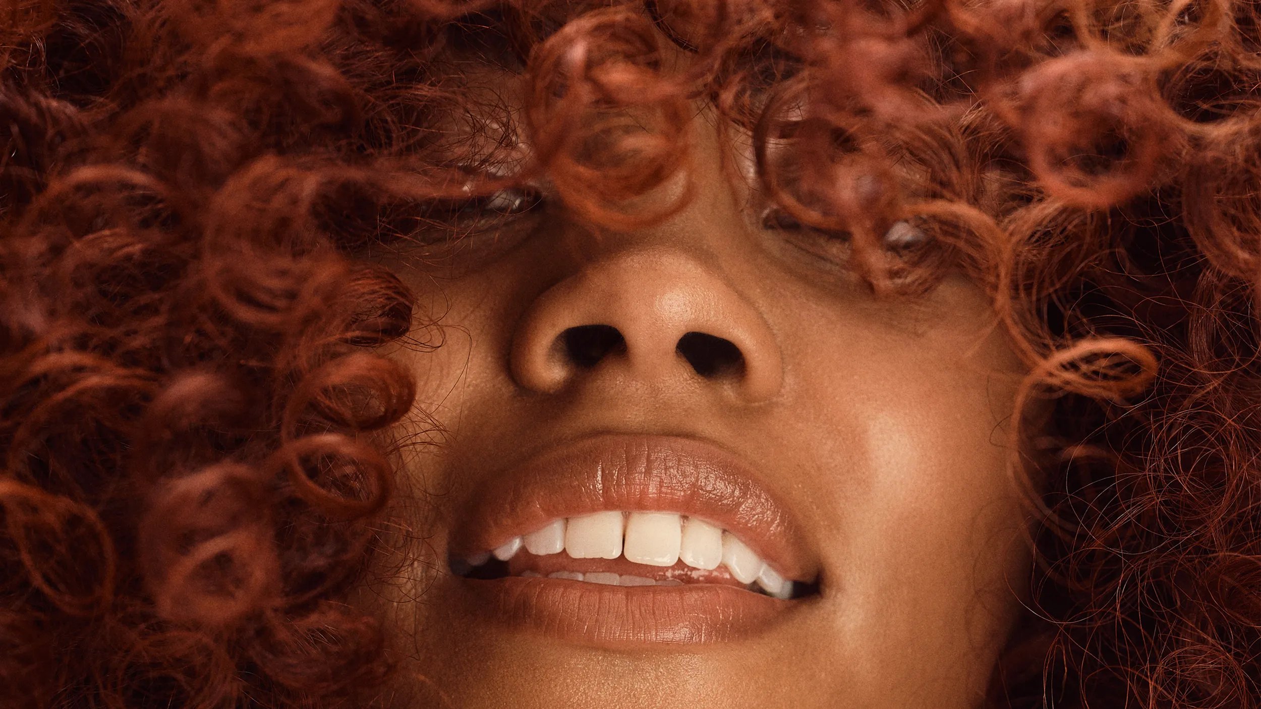 Model with curly hair, styled using Wella Professionals products