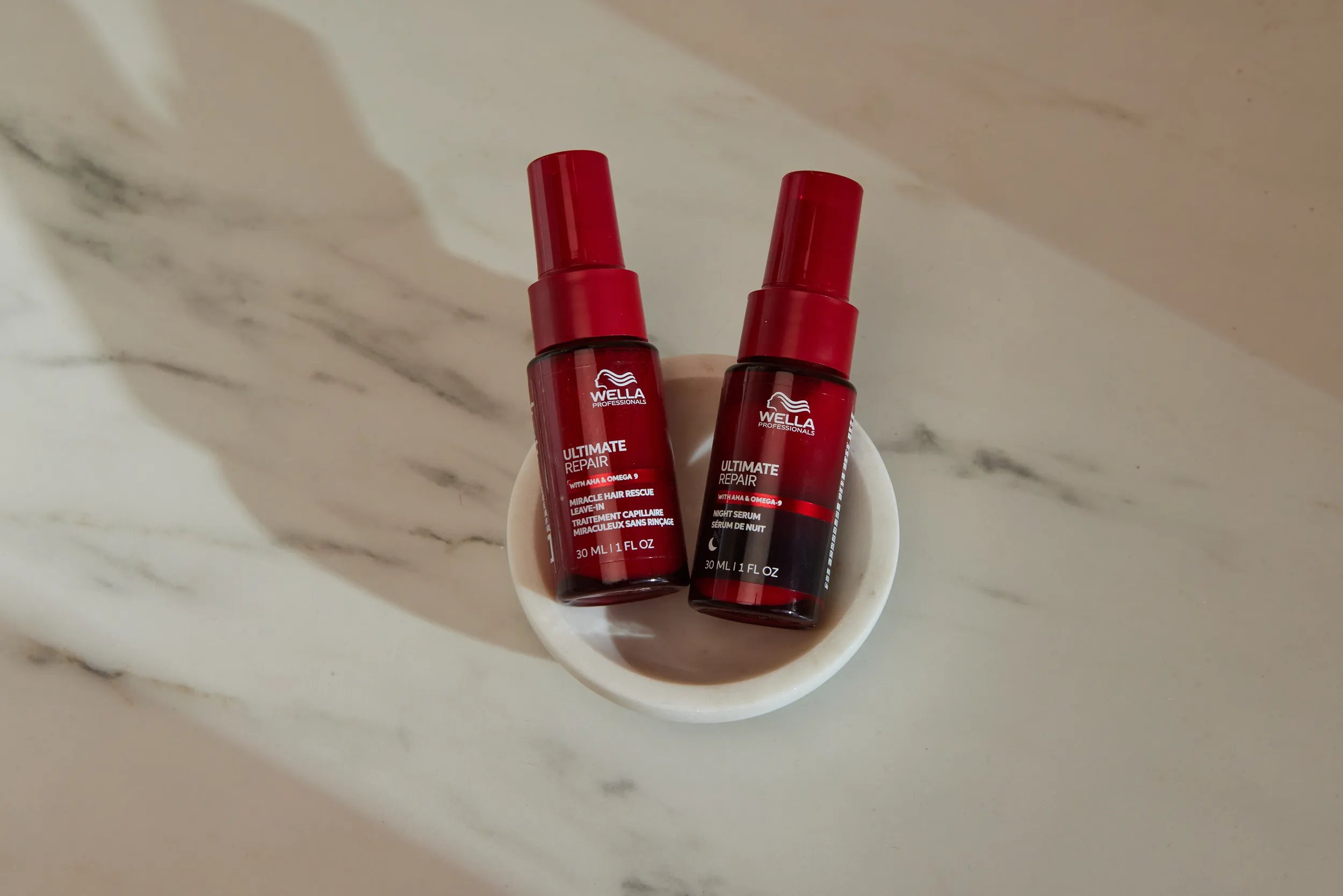 ULTIMATE REPAIR Miracle Hair Rescue and Night Serum in a marble pot.