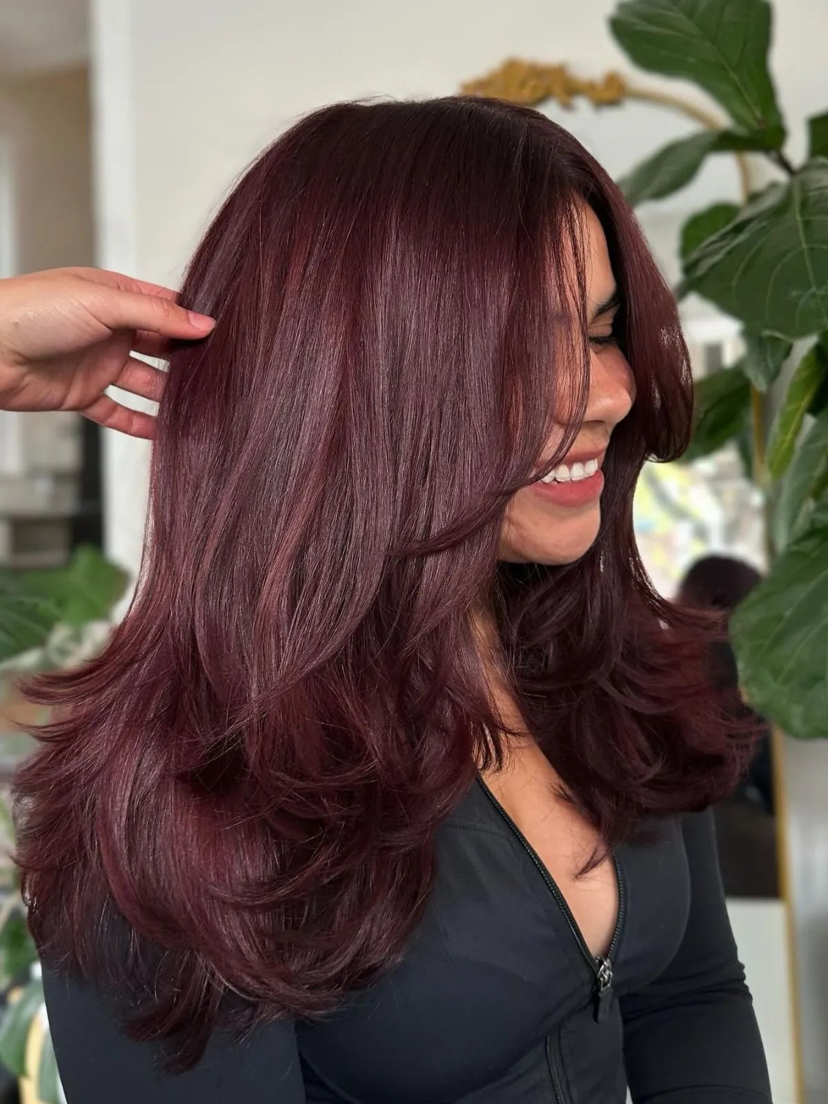Model with long, straight, glossy burgundy hair.