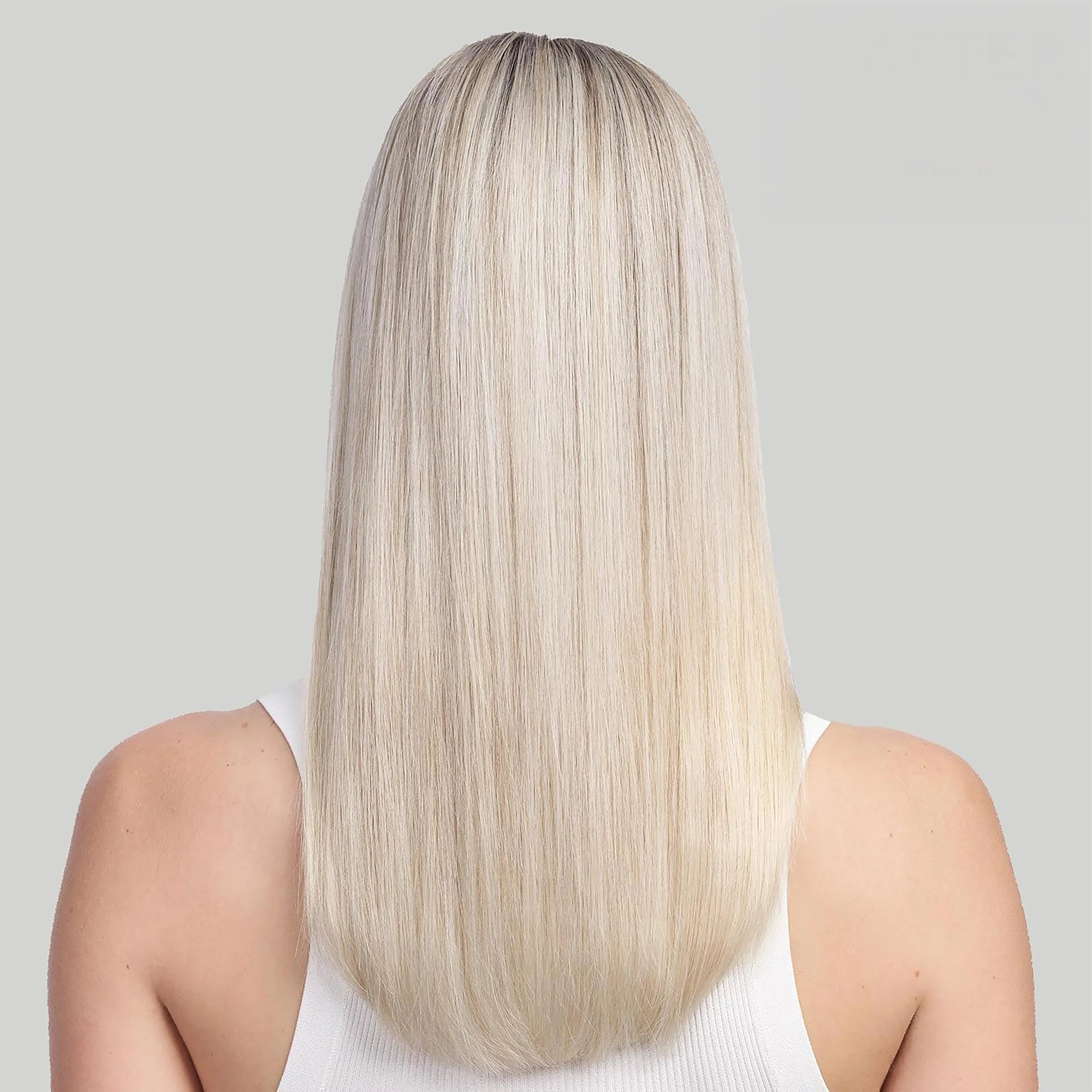 Woman with long blonde hair faces away from the camera. Hair looks shiny and healthy. Text reads after with Ultimate Repair steps 1,2&3 and blow-dry. 