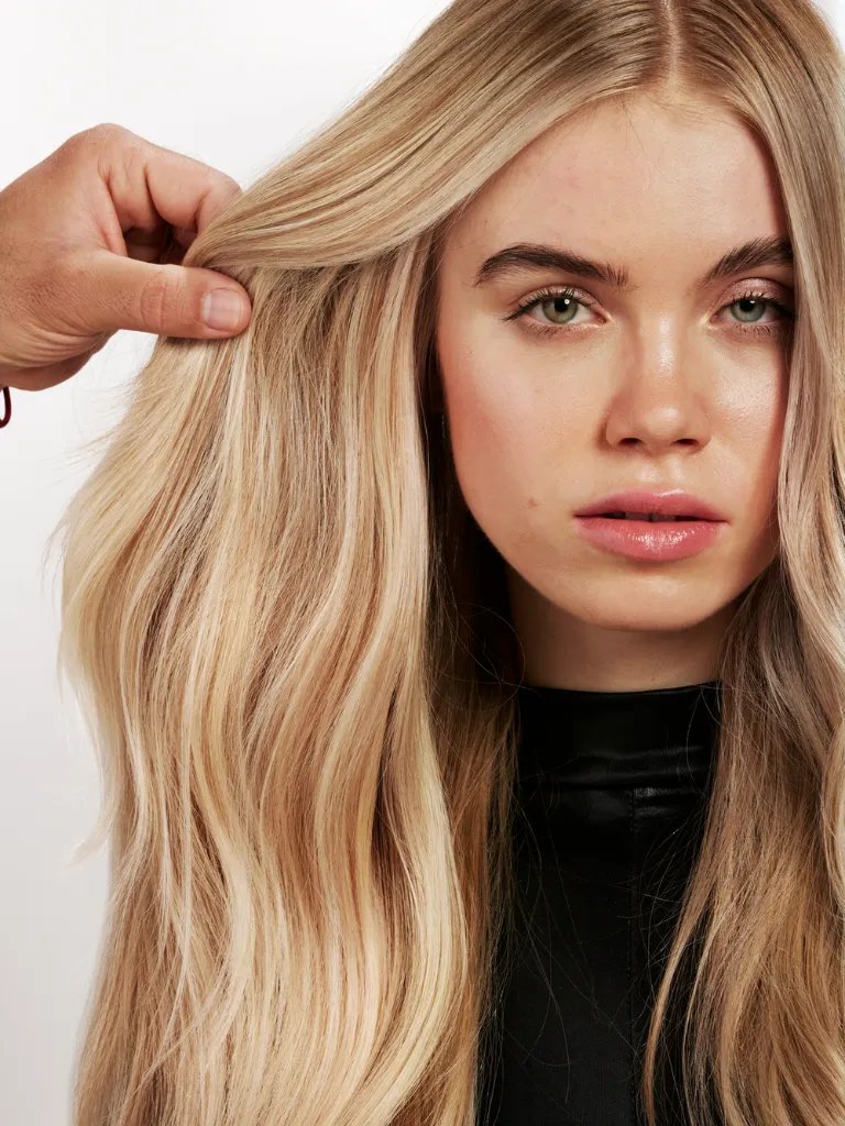 Closer look at the blended highlights through a model’s golden blonde hair.