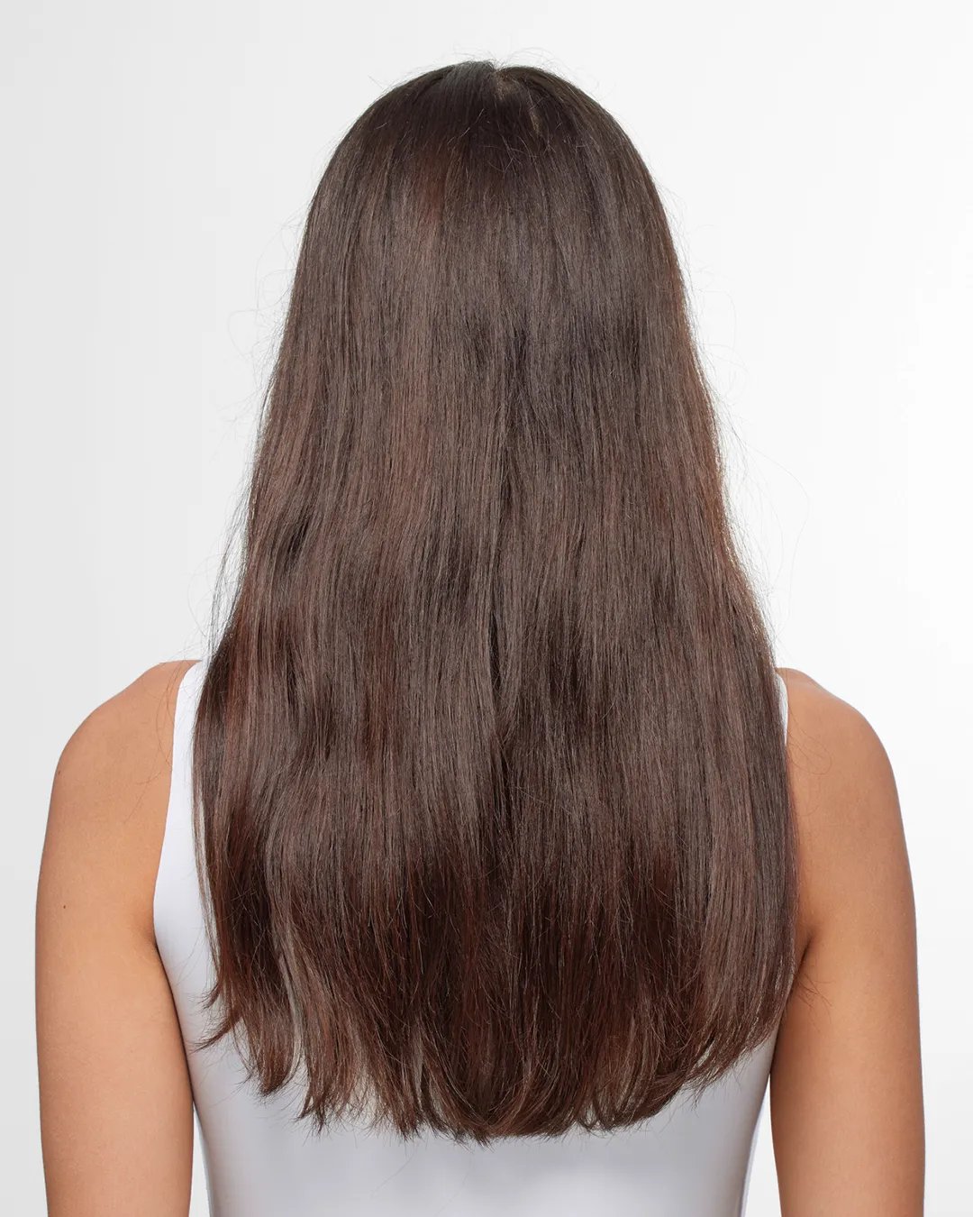 Model faces away from the camera. They have long brown hair that looks dull and in need of care.