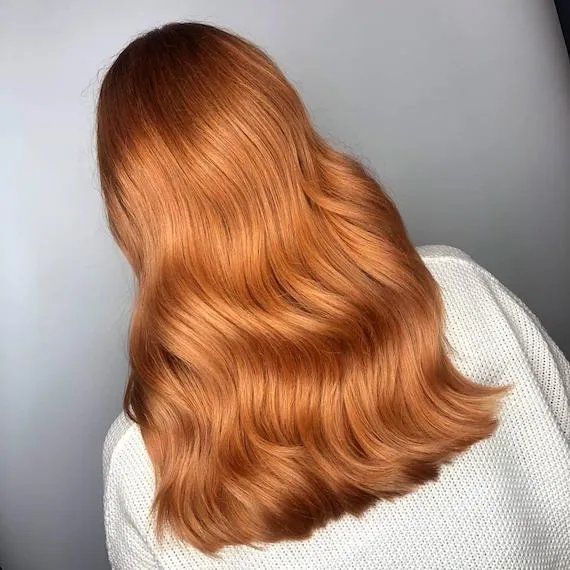 Back of model’s head with long,  wavy hair.