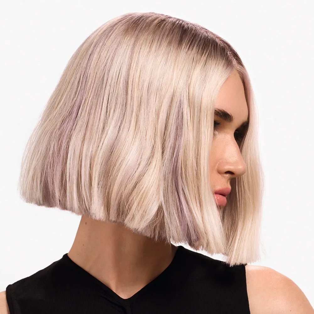 Side profile of woman with short blonde bob hair. 
