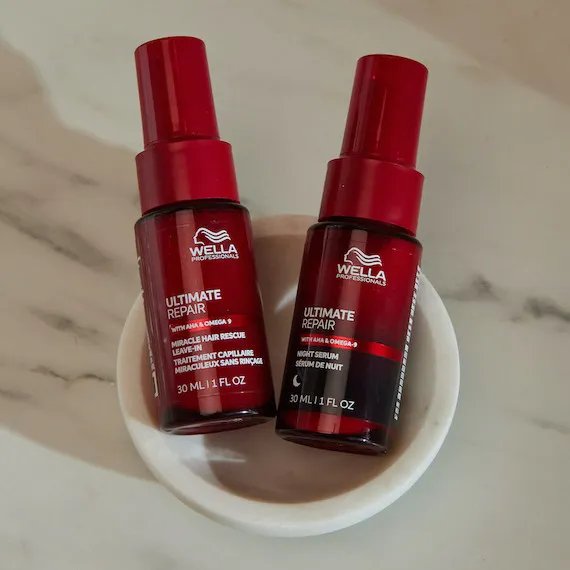 Wella Professionals Ultimate Repair Miracle Rescue and Ultimate Repair overnight serum against a marble background. 