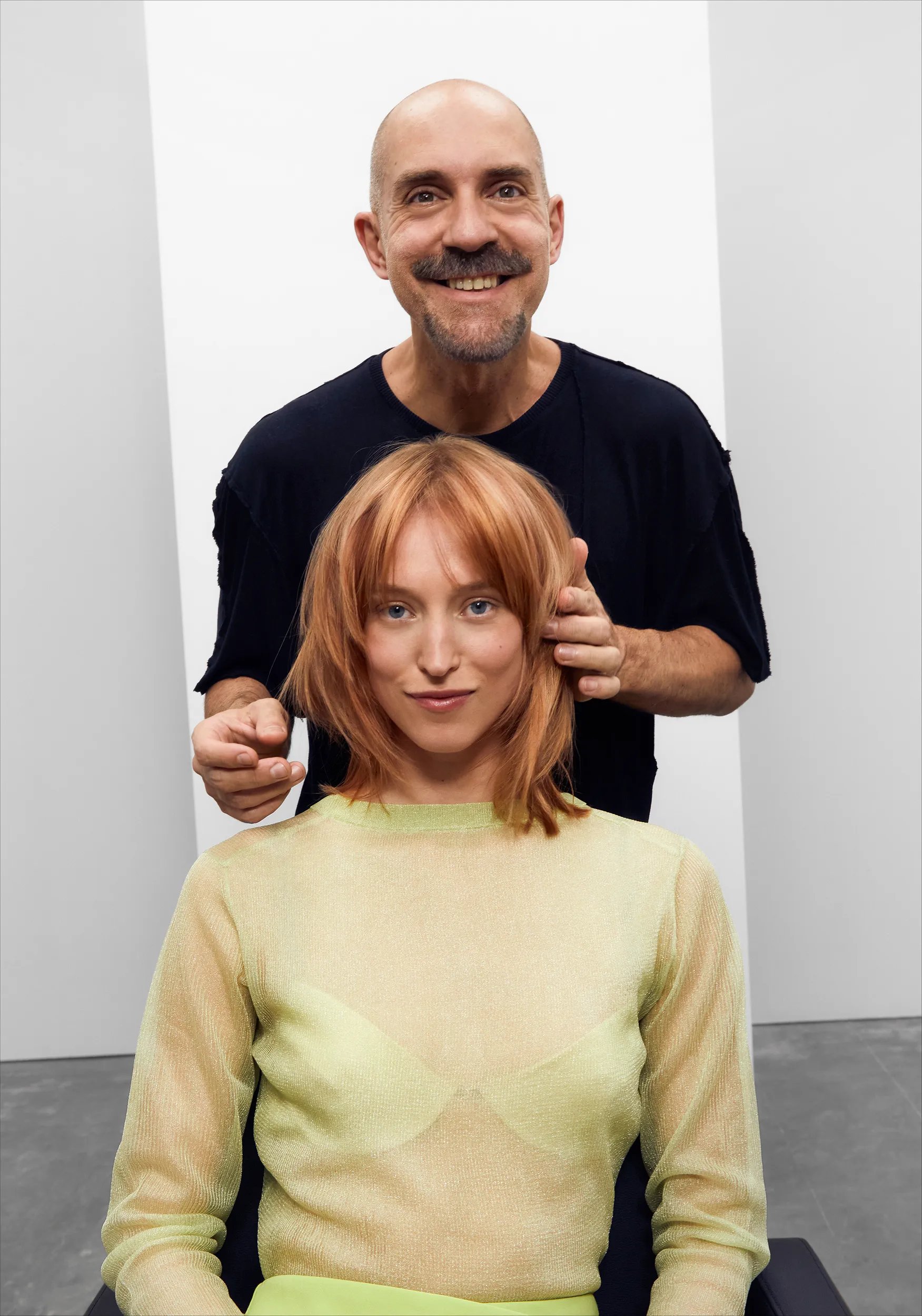 Model with stylist looking to a mirror