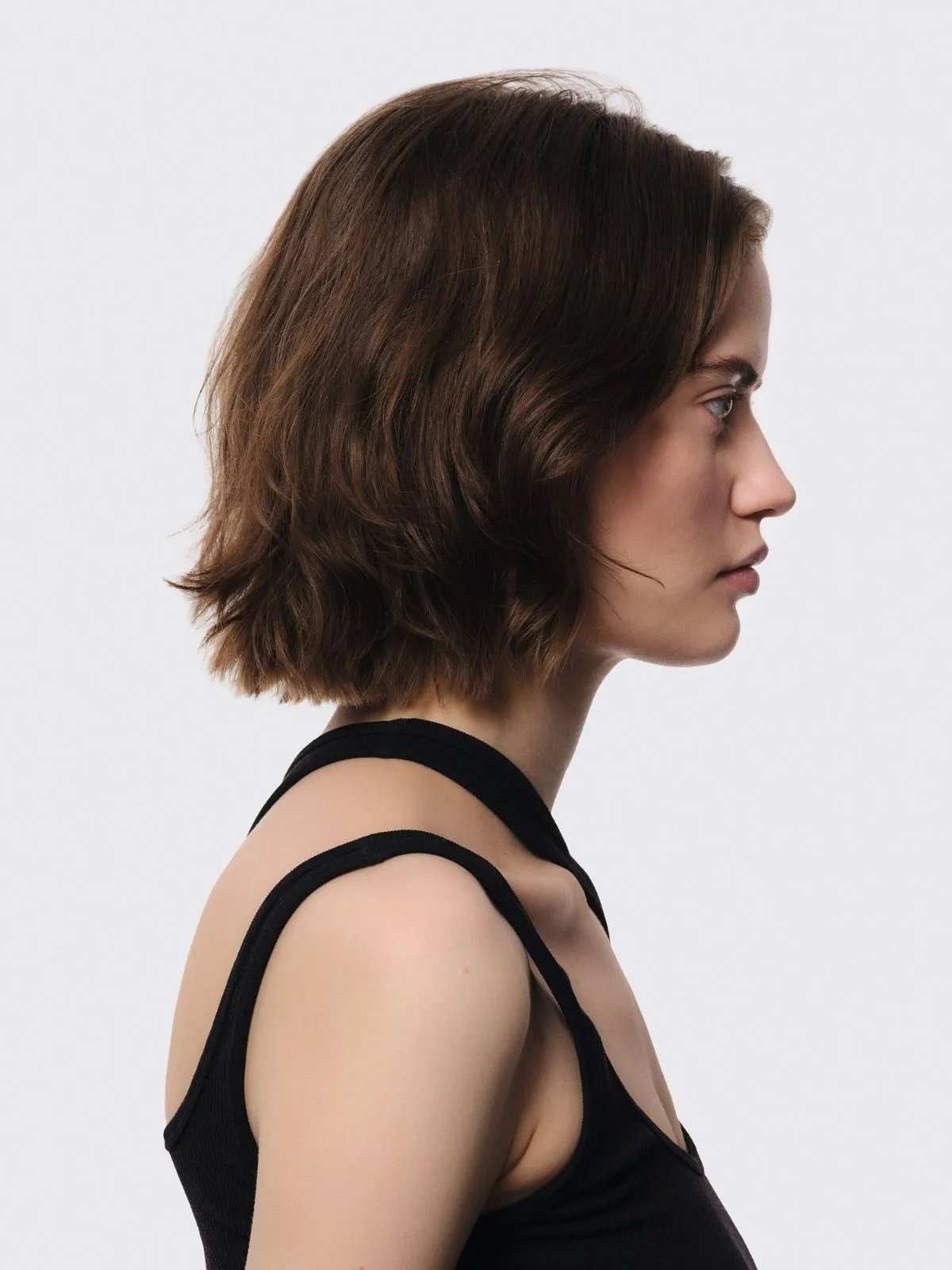 Model with short, medium brown hair.