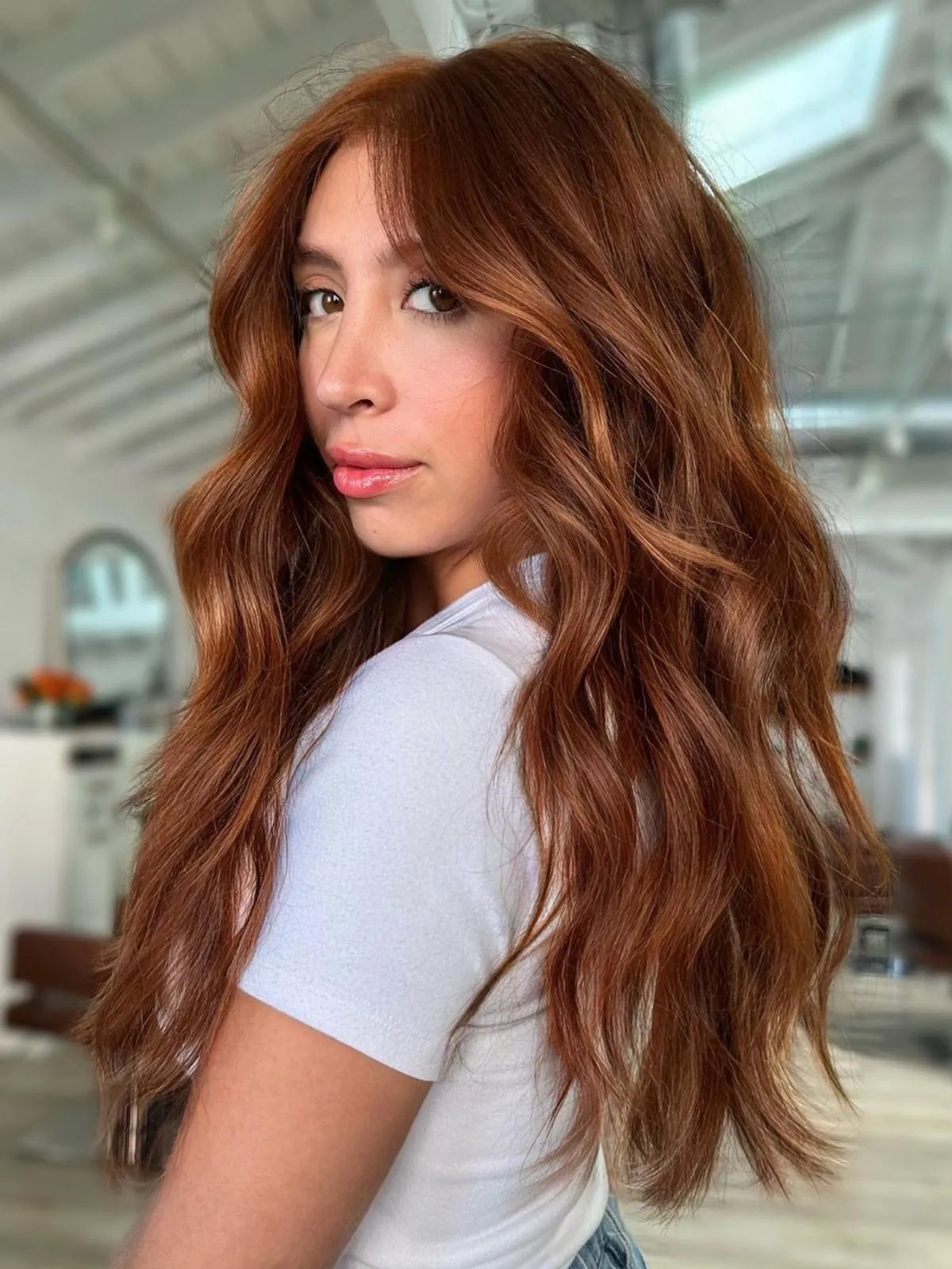 Model with long, loosely tousled, chestnut auburn hair.