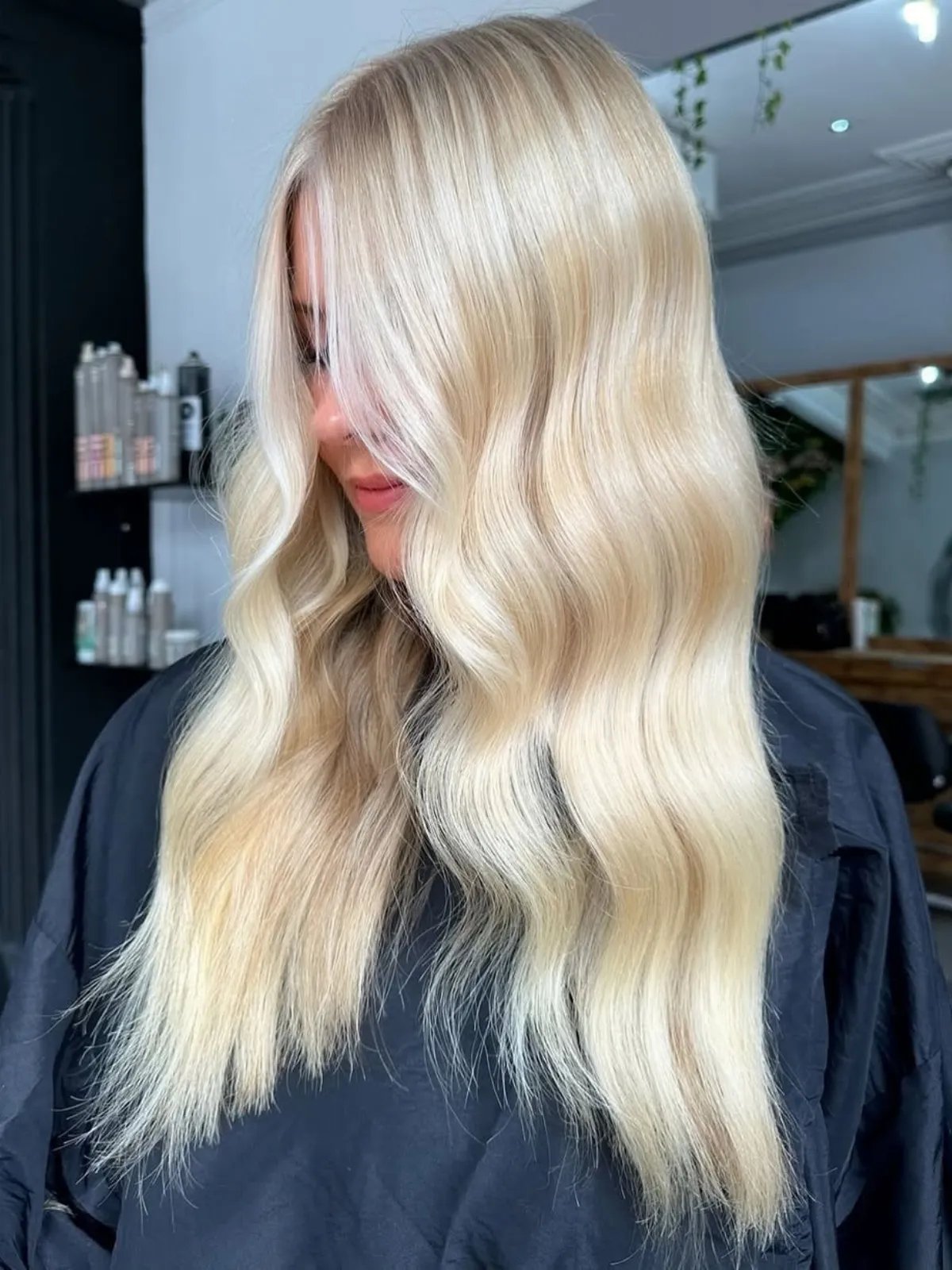 Model with long, glossy, bright champagne blonde hair. 