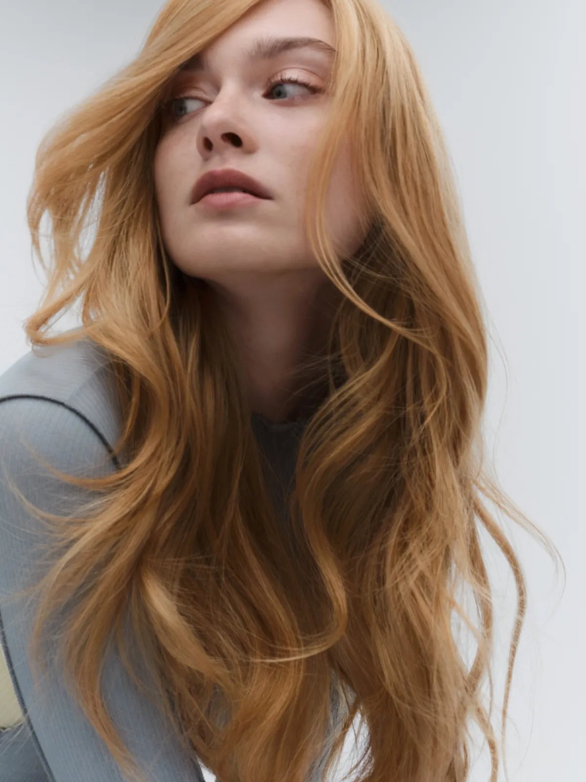 Model with loosely tousled, strawberry blonde hair.