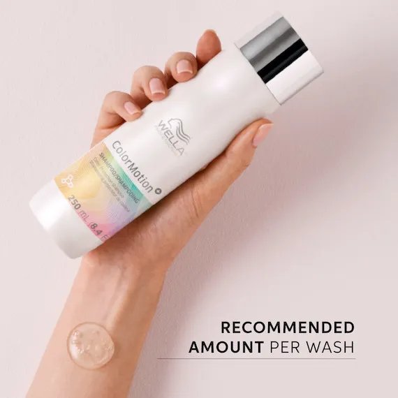 A model’s hand holds up a bottle of ColorMotion+ Color Protection Shampoo.