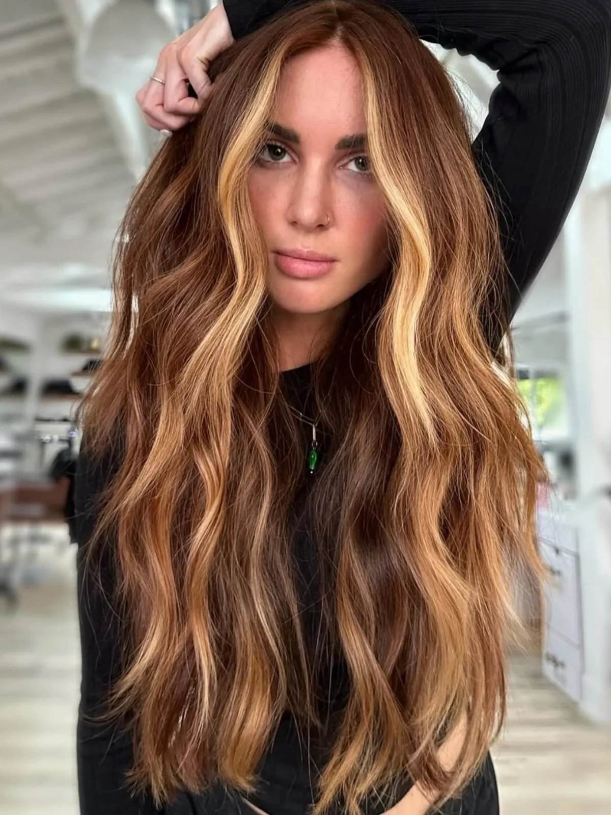 Model with chestnut brown hair featuring a golden blonde face frame.