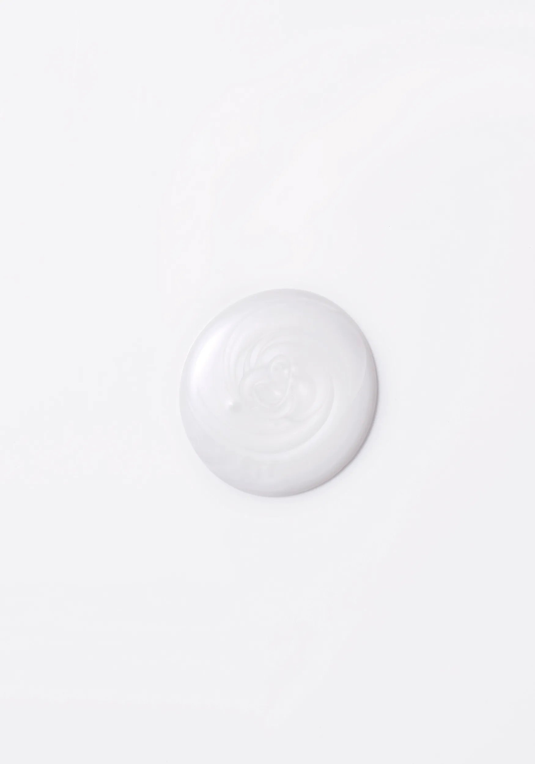 Close-up photograph of a circular blob of Invigo Brilliance shampoo for fine hair on a white background, with text saying 'antioxidant shield, helps control the oxidation process after coloring' and 'metal purifier, protects from harmful metals in water'.