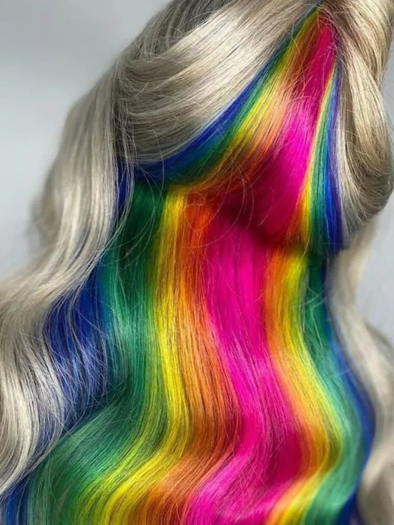 Model’s icy blonde hair features rainbow tones painted through the lower layers to represent the Pride flag.