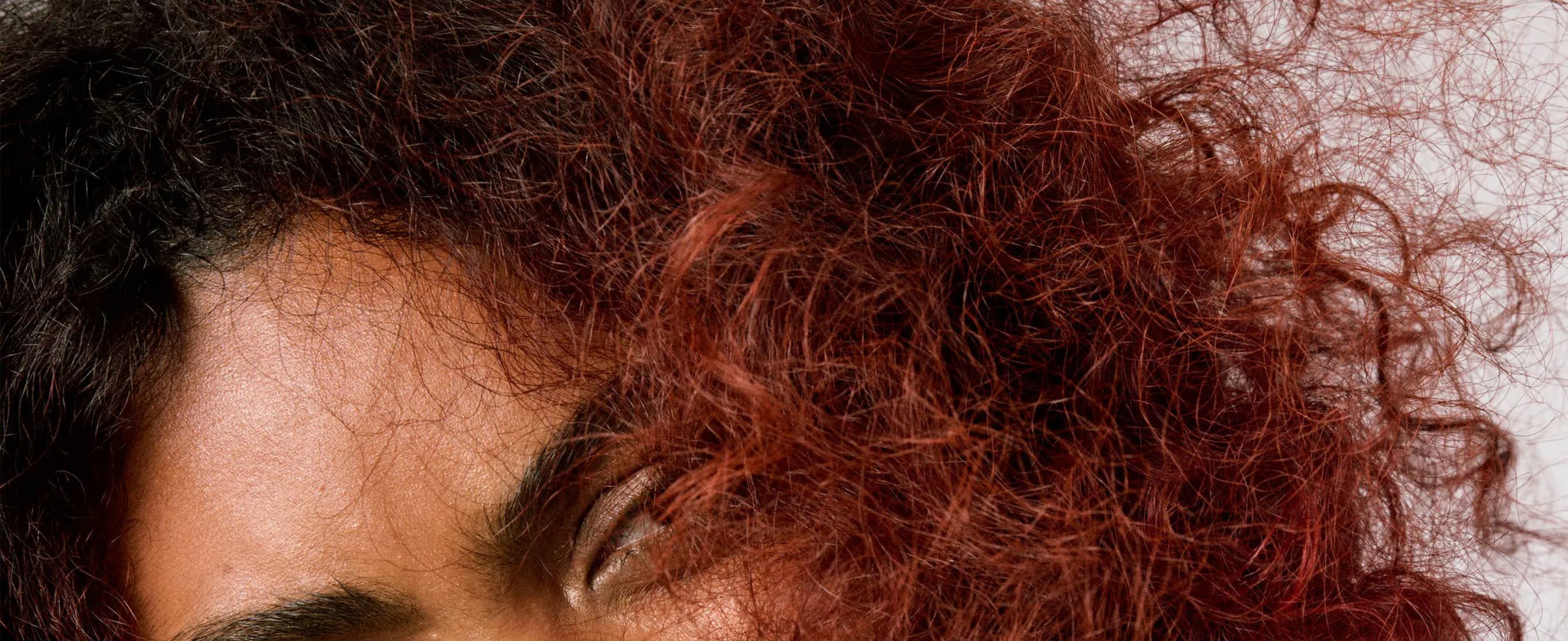 Model with dry red curly hair