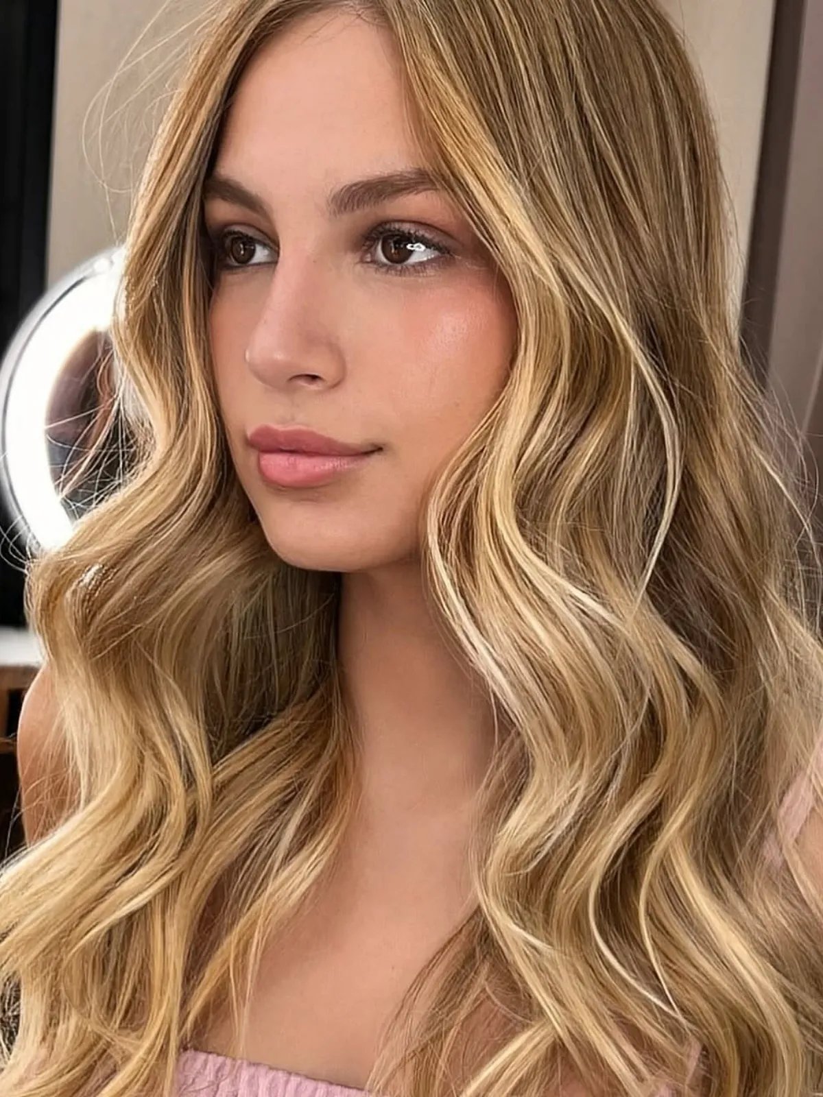 Honey blonde waves with soft dimension.