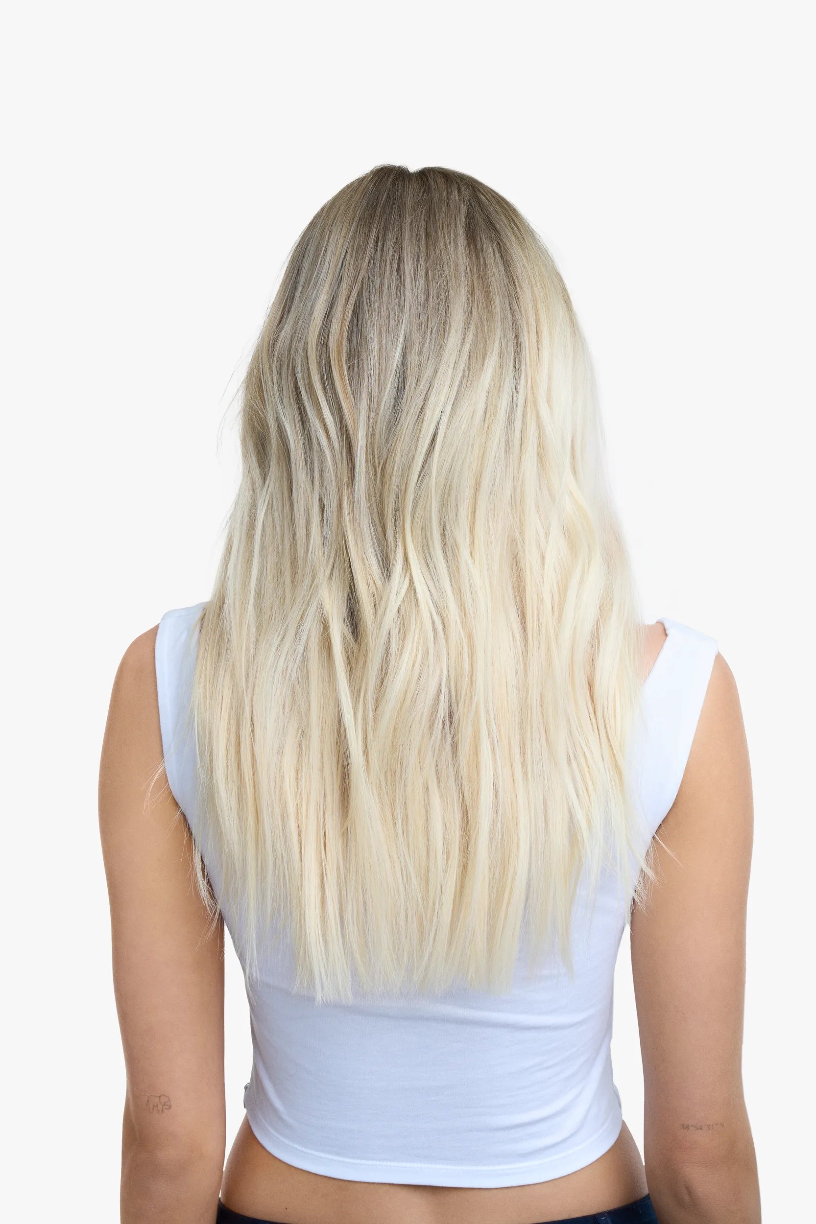 Model with short blonde bob faces away from the camera. Hair looks fresh, healthy and the brassy tones shown in the before image are gone.