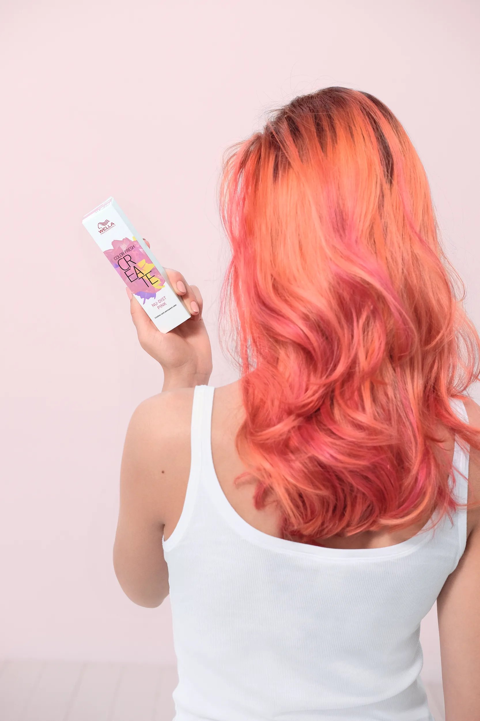 Image of woman with peach hair holding a Color Fresh Create box