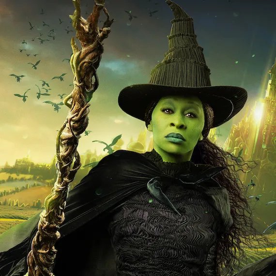 Cynthia Erivo appears as Elphaba, wearing a black witch hat and holding a broom.