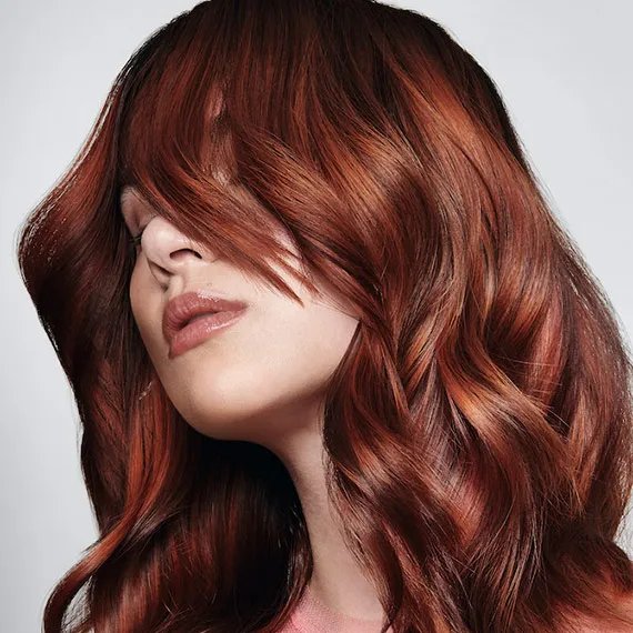 Model with mid-length copper brown hair. 