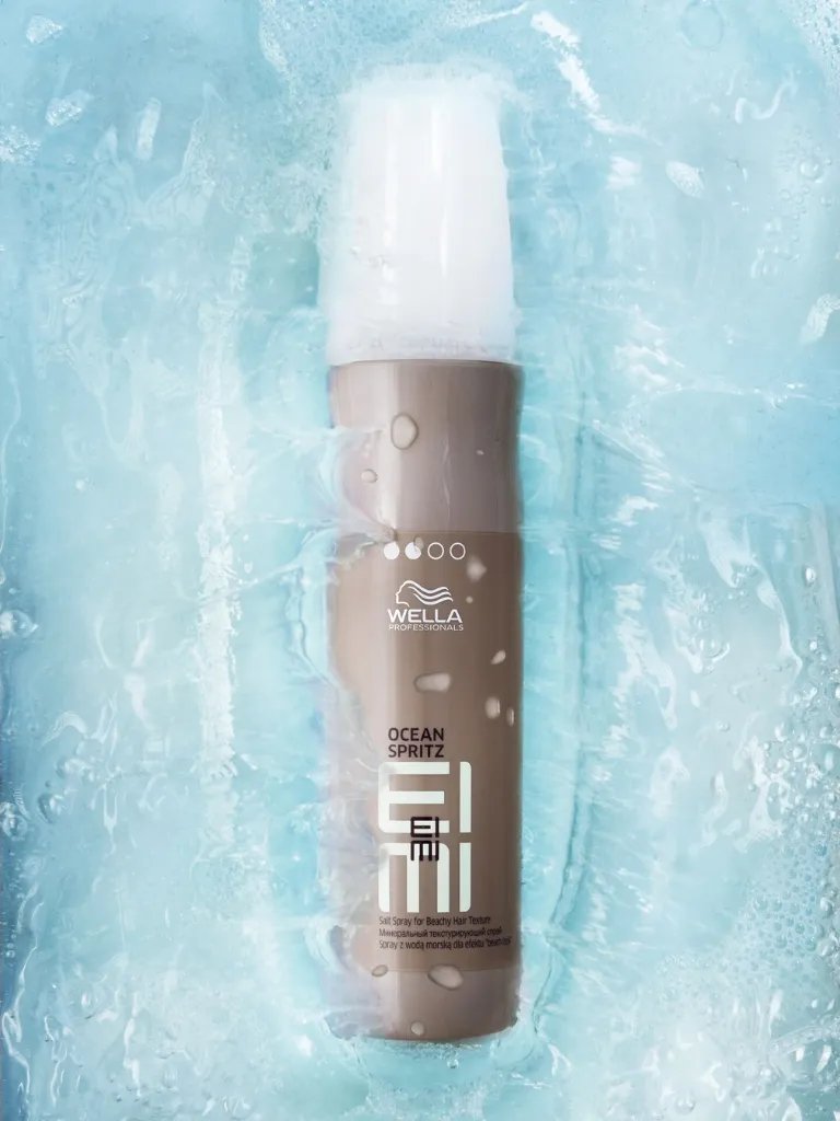 EIMI Ocean Spritz bottle in a pool of water.