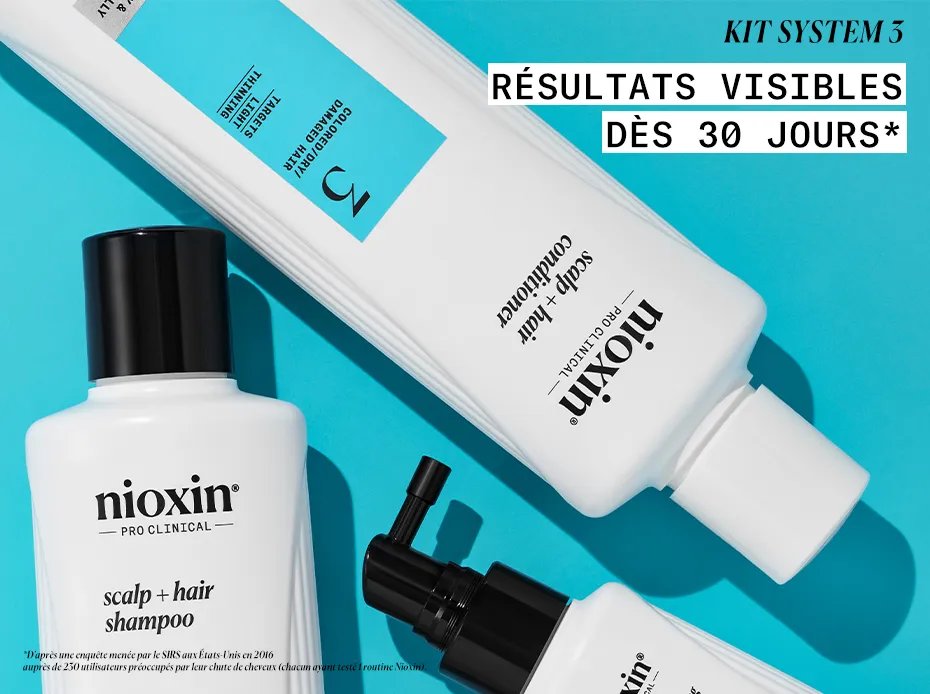 Nioxin system 3 shampoo, conditioner and hair thickening treatment against blue background